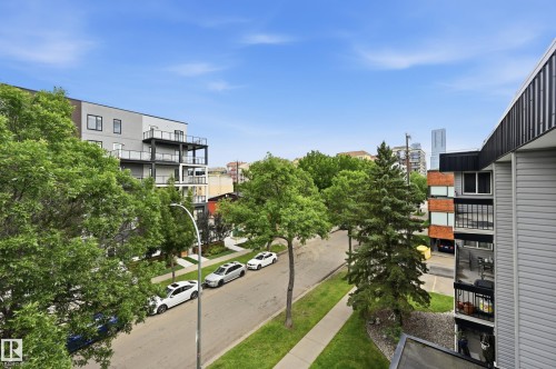 Streetscape featuring mature trees and a residential street with parked vehicles - #433 11217 103 Av Nw, Edmonton, AB - Outdoor With Balcony