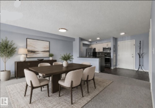 Open-concept living and dining area featuring a wood-finish dining table, neutral upholstered seating, recessed ceiling lighting, and large-scale artwork - #217 12045 22 Av Sw, Edmonton, AB - Indoor Photo Showing Dining Room