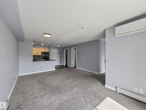 Living area featuring a spacious open concept layout - #217 12045 22 Av Sw, Edmonton, AB - Indoor Photo Showing Other Room