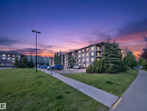Multi-story residential building with private balconies and stone-look siding - #217 12045 22 Av Sw, Edmonton, AB - Outdoor