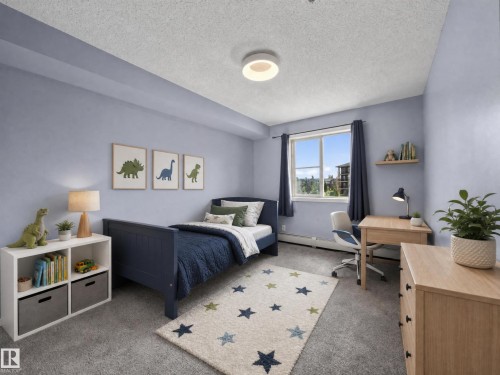 Room with soft blue walls and light gray carpet - #217 12045 22 Av Sw, Edmonton, AB - Indoor Photo Showing Bedroom