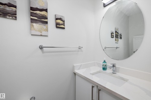 Modern bathroom vanity with an integrated rectangular sink, stone-finish countertop, and chrome faucet - 2803 12 Street Nw, Edmonton, AB - Indoor Photo Showing Bathroom