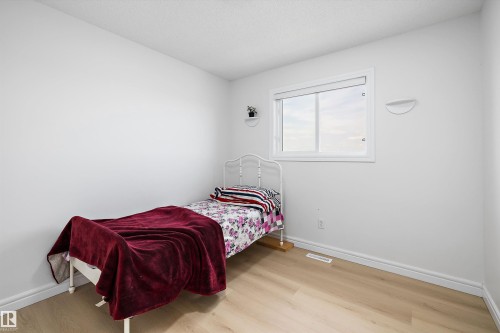 White walls complement light wood-finish flooring - 2803 12 Street Nw, Edmonton, AB - Indoor Photo Showing Bedroom