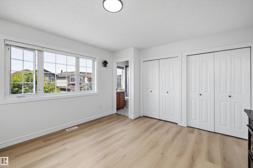 Bright room featuring light wood-finish flooring, white walls, and a large multi-pane window - 2803 12 Street Nw, Edmonton, AB - Indoor
