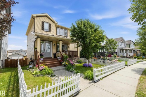 Two-story residence featuring light-toned horizontal siding with dark accent shutters - 2803 12 Street Nw, Edmonton, AB - Outdoor With Deck Patio Veranda With Facade