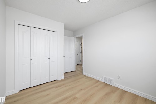 Bright interior space featuring light wood-finish flooring, white walls, and white baseboards - 2803 12 Street Nw, Edmonton, AB - Indoor Photo Showing Other Room