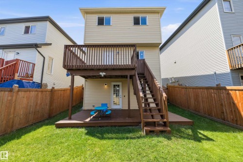 Two-story exterior with siding, featuring a multi-level wooden deck and stairs - 2803 12 Street Nw, Edmonton, AB - Outdoor With Deck Patio Veranda With Exterior