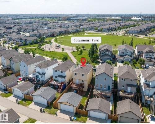 Aerial view of a residential property with a detached garage, featuring a rear deck and a fenced yard - 2803 12 Street Nw, Edmonton, AB - Outdoor With View