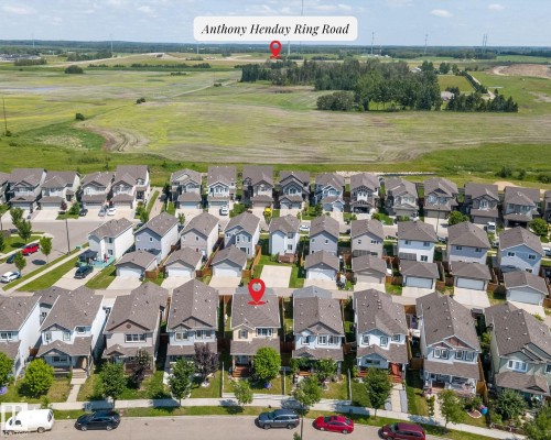Aerial perspective showcasing a residential street with detached homes, each featuring individual driveways and front yards - 2803 12 Street Nw, Edmonton, AB - Outdoor With View