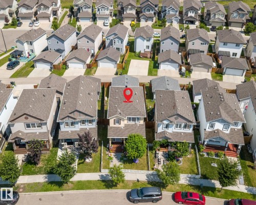 Modern residential property featuring a tan exterior with white trim, a dark shingle roof, and a front porch - 2803 12 Street Nw, Edmonton, AB - Outdoor With View