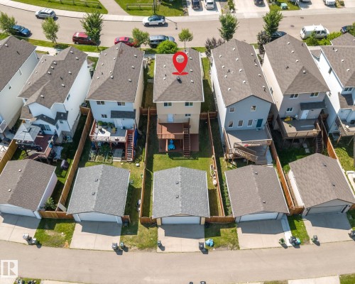 Two-story property featuring a rear deck and a detached garage with a dark shingle roof - 2803 12 Street Nw, Edmonton, AB - Outdoor