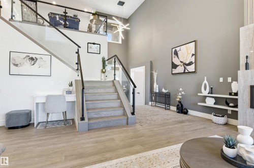 Stairway featuring wood finished floors and a high ceiling - 3167 Cameron Heights Way Nw, Edmonton, AB - Indoor Photo Showing Other Room