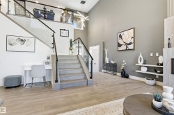 Stairway featuring wood finished floors and a high ceiling - 