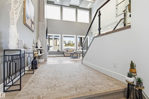 Entryway featuring stairway, light wood-type flooring, and a high ceiling - 3167 Cameron Heights Way Nw, Edmonton, AB - Indoor Photo Showing Other Room