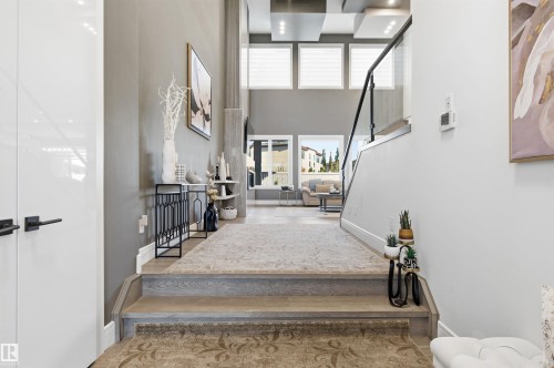 Stairway featuring a towering ceiling and wood finished floors - 3167 Cameron Heights Way Nw, Edmonton, AB - Indoor Photo Showing Other Room