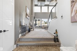 Stairway featuring a towering ceiling and wood finished floors - 