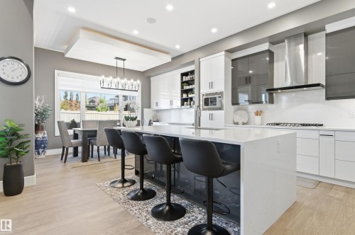 Kitchen featuring white cabinetry, a breakfast bar, modern cabinets, pendant lighting, and recessed lighting - 3167 Cameron Heights Way Nw, Edmonton, AB - Indoor Photo Showing Kitchen With Upgraded Kitchen