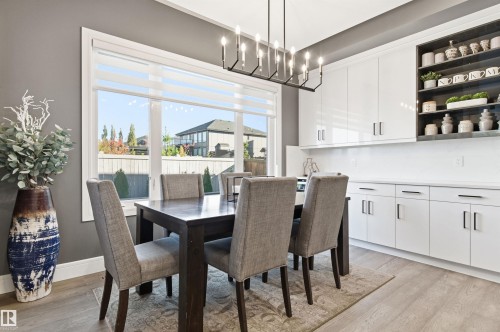 Dining space featuring light wood-style flooring and a chandelier - 3167 Cameron Heights Way Nw, Edmonton, AB - Indoor Photo Showing Dining Room