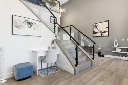 Staircase with wood finished floors and baseboards - 