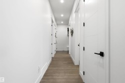 Corridor featuring recessed lighting and dark wood-style flooring - 