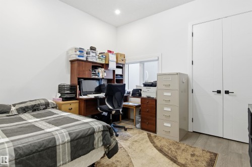 Bedroom with light wood finished floors and a desk - 3167 Cameron Heights Way Nw, Edmonton, AB - Indoor