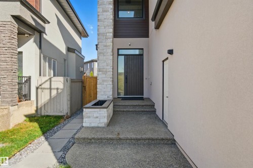 View of exterior entry with stucco siding, stone siding, and a gate - 3167 Cameron Heights Way Nw, Edmonton, AB - Outdoor