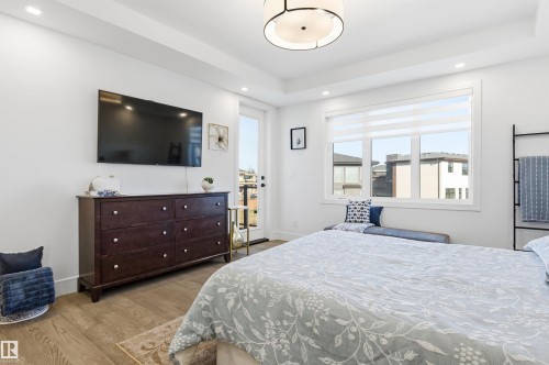 Bedroom with light wood-type flooring, recessed lighting, and a tray ceiling - 3167 Cameron Heights Way Nw, Edmonton, AB - Indoor Photo Showing Bedroom