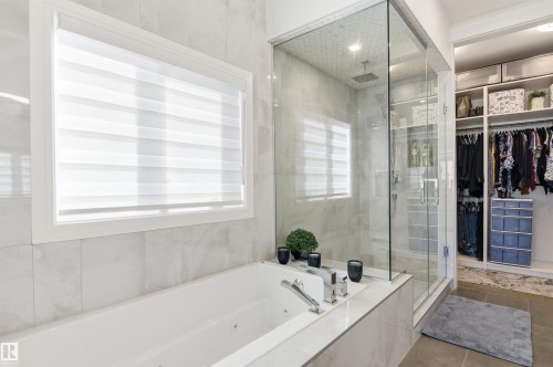 Full bathroom with a walk in closet, a tub with jets, a stall shower, and tile patterned floors - 3167 Cameron Heights Way Nw, Edmonton, AB - Indoor Photo Showing Bathroom
