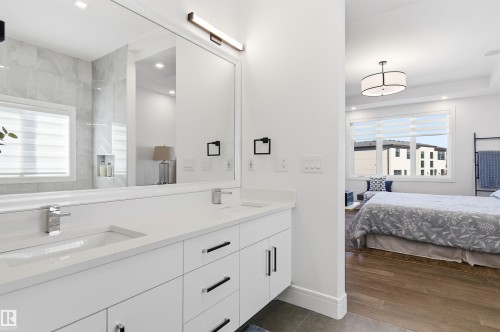 Ensuite bathroom featuring double vanity, recessed lighting, and dark wood-style floors - 3167 Cameron Heights Way Nw, Edmonton, AB - Indoor Photo Showing Bathroom