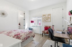 Bedroom featuring light wood finished floors and a desk - 