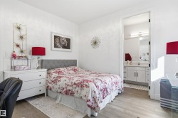 Bedroom with light wood-style flooring and ensuite bathroom - 