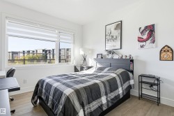 Bedroom featuring wood finished floors and baseboards - 