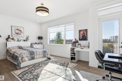 Bedroom featuring an office area and wood finished floors - 
