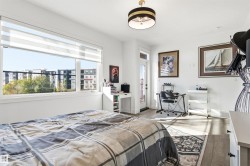 Bedroom featuring wood finished floors and a desk - 