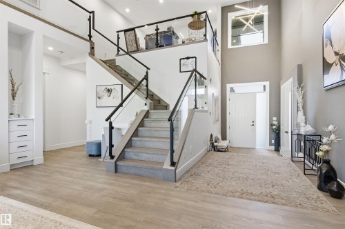 Entryway featuring light wood-type flooring, stairway, and a towering ceiling - 3167 Cameron Heights Way Nw, Edmonton, AB - Indoor Photo Showing Other Room