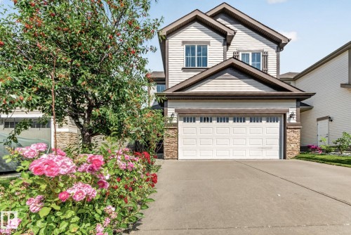 Contemporary two-story residence featuring light siding and a stone veneer accent - 1115 61 Street Sw, Edmonton, AB - Outdoor