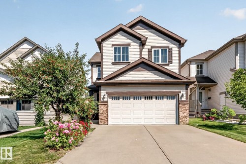 Two-story residence featuring light-colored horizontal siding and dark brown trim accents - 1115 61 Street Sw, Edmonton, AB - Outdoor With Facade