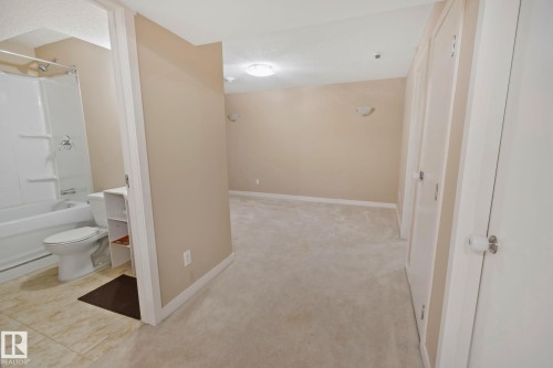Well-lit room featuring neutral-toned walls, carpeted flooring, and white trim - 1115 61 Street Sw, Edmonton, AB - Indoor Photo Showing Bathroom