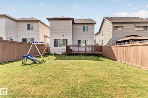 Expansive green lawn with a wood fence enclosure - 1115 61 Street Sw, Edmonton, AB - Outdoor With Exterior