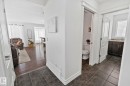 View of the main floor featuring tiled flooring, a powder room with a toilet, and another bathroom with a vanity and sink - 1115 61 Street Sw, Edmonton, AB 