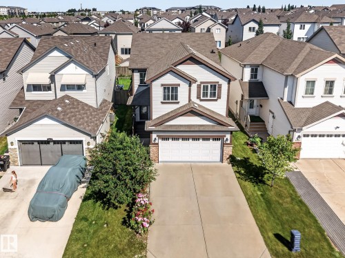 Two-story residence featuring light-colored siding with brown trim accents - 1115 61 Street Sw, Edmonton, AB - Outdoor With Facade