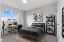 Carpeted room featuring a large window, a ceiling-mounted light fixture, and a white paneled door - 