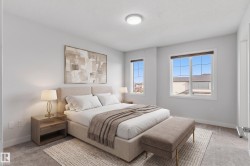 Carpeted bedroom featuring two windows with white trim, a flush mount ceiling light, and light gray wall paint - 