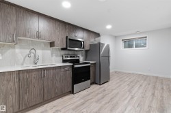 Kitchen featuring wood-finish cabinetry, stainless steel appliances, a white solid surface countertop, and tile backsplash - 