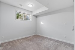 Carpeted room with light grey walls, a single window, and flush-mount ceiling light fixture - 