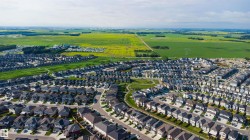 Expansive residential development featuring numerous single-family homes and a curving street layout - 