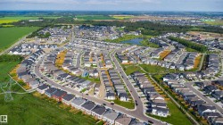 Aerial perspective showcasing a developed residential community with numerous single-family homes - 