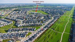 Aerial perspective showcasing a residential neighborhood with numerous homes - 