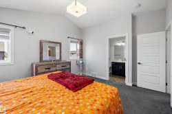 Vaulted ceilings and light gray walls create an airy ambiance in this carpeted room - 