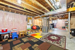 Unfinished basement with concrete flooring, and ample utility access - 